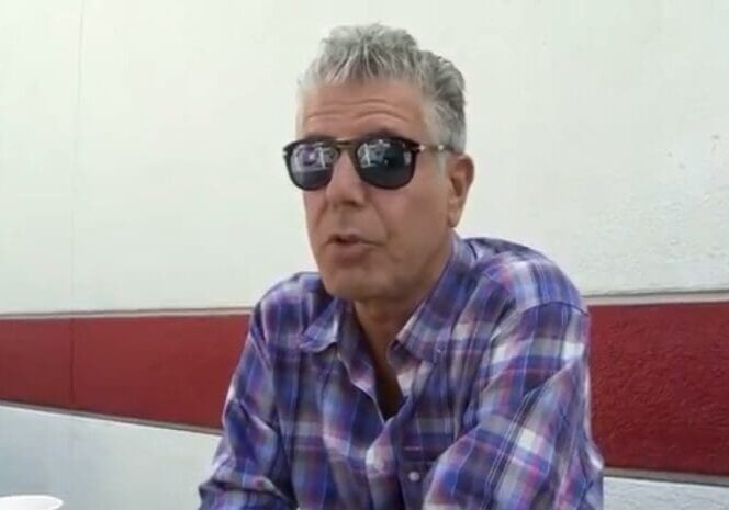 A man in sunglasses sitting at a table.